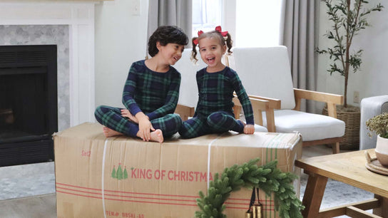 two kids sitting on King Of Christmas box